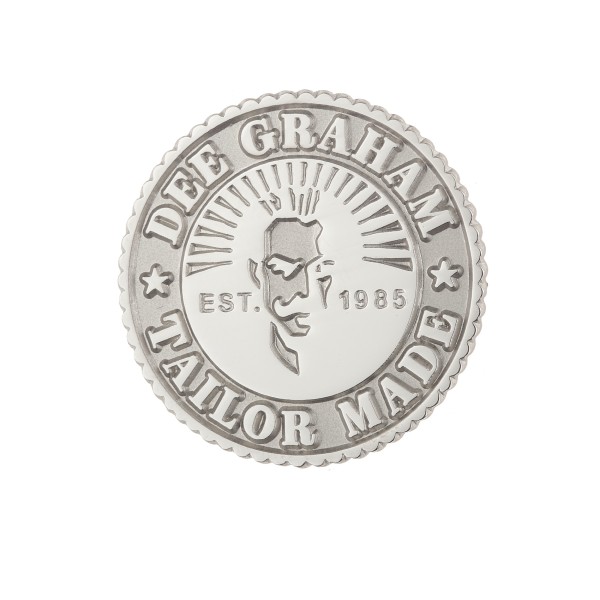 Silver die-struck badge with a silhouette of a face and text that reads